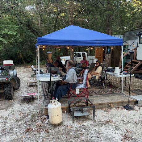 A cozy community gathering area with residents socializing and enjoying each other's company, outdoors at Lavender Place & RV.